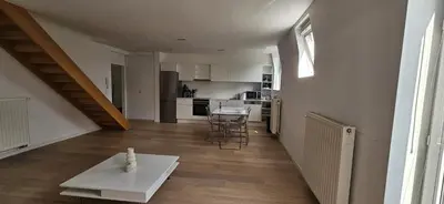 a living room with a table and a kitchen at Wonderful Brussels in Uccle in Brussels
