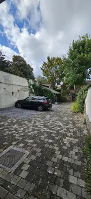 a car parked in a parking lot next to a wall at Wonderful Brussels in Uccle in Brussels