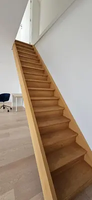 a wooden staircase in a room with a desk at Wonderful Brussels in Uccle in Brussels