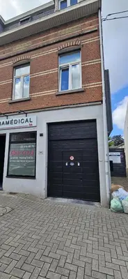a building with two garage doors in front of it at Wonderful Brussels in Uccle in Brussels
