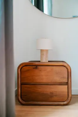 a lamp sitting on a dresser next to a table at Slow Moments in Brussels in Brussels