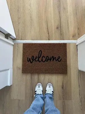 a person standing on the floor with a welcome mat at 3- Duplex Lumineux au coeur d'Ixelles in Brussels