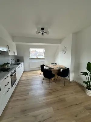 a kitchen with a table and chairs in a room at 3- Duplex Lumineux au coeur d'Ixelles in Brussels