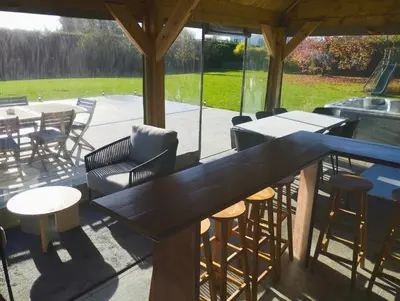 a patio with tables and chairs and a grill at Il Giardino Segreto in Waterloo