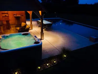a jacuzzi tub sitting on a patio at night at Il Giardino Segreto in Waterloo