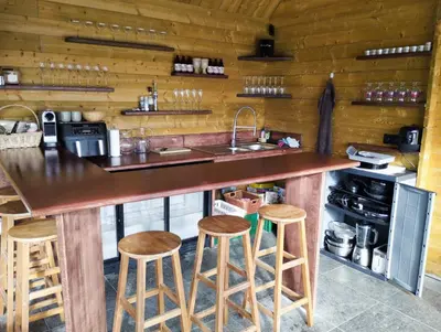 a kitchen with a counter with stools and a sink at Il Giardino Segreto in Waterloo