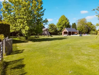 a large yard with a playground and a house at Il Giardino Segreto in Waterloo