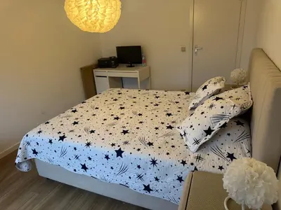 a bedroom with a bed and a desk with a computer at Luxurious apartment in Auderghem in Brussels