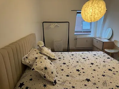 a bedroom with a bed with a comforter with stars at Luxurious apartment in Auderghem in Brussels