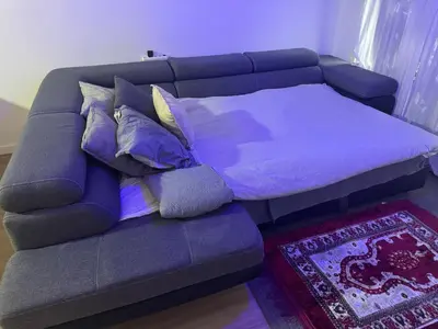 a purple couch with pillows on it in a room at Luxurious apartment in Auderghem in Brussels