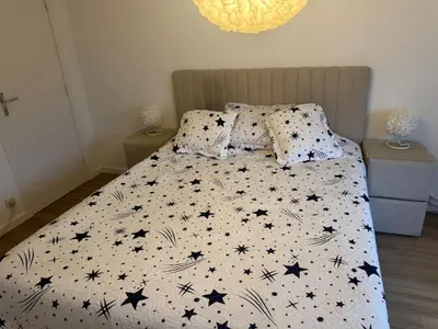 a bedroom with a bed with black stars on it at Luxurious apartment in Auderghem in Brussels