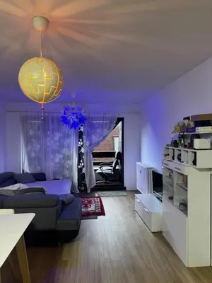 a purple living room with a couch and a chandelier at Luxurious apartment in Auderghem in Brussels
