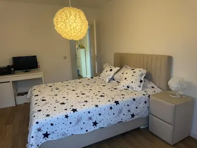 a bedroom with a bed with black stars on it at Luxurious apartment in Auderghem in Brussels