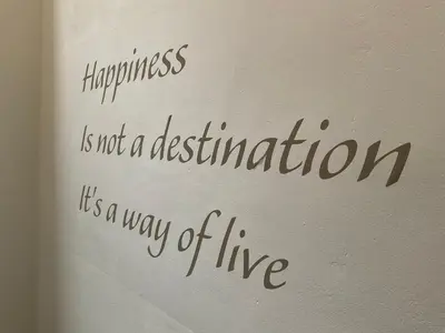 a writing on a wall with happiness is not a destination at Appartement historisch centrum Antwerpen in Antwerp
