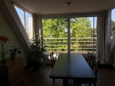 a dining room with a table and a large window at Fokus time out 2 in Dessel
