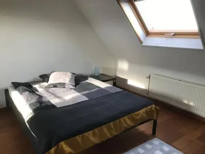 a bedroom with a bed in a room with a window at Fokus time out 2 in Dessel
