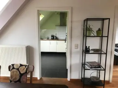 a living room with a kitchen and a stair case at Fokus time out 2 in Dessel