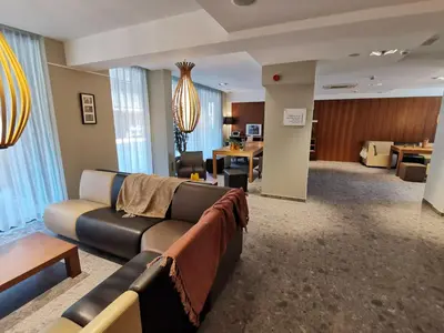 a living room with a couch and a table at Tower Hotel Aalst in Aalst