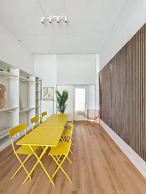 a yellow table and chairs in an empty room at Central Spot - Louise in Brussels