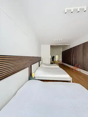 two beds in a room with white beds at Central Spot - Louise in Brussels