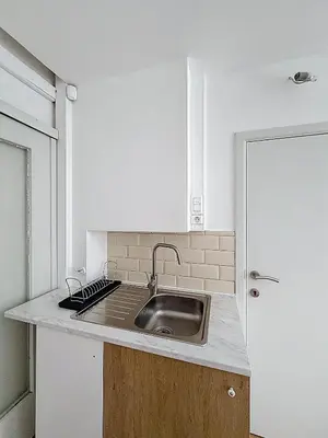a kitchen with a sink and a stove at Central Spot - Louise in Brussels