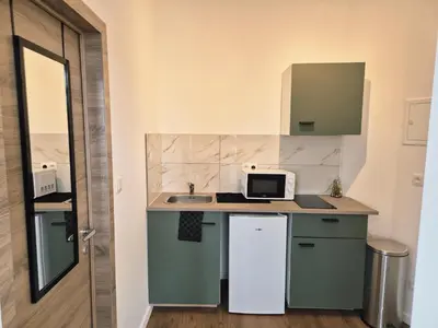 a small kitchen with a sink and a microwave at Studios - European Quarter in Brussels