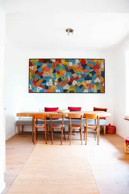 a dining room with tables and a painting on the wall at Le Paddock by Ernesst in Lubbeek