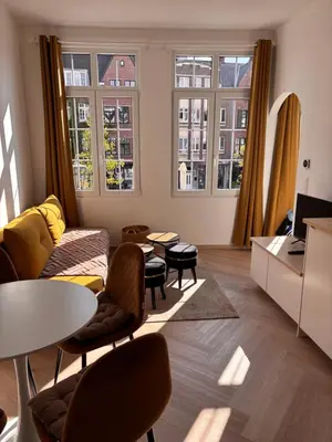 a living room with a couch and a table at Studio Miravelle in Antwerp