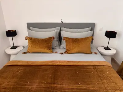 a bedroom with a large bed with two lamps at Studio Miravelle in Antwerp