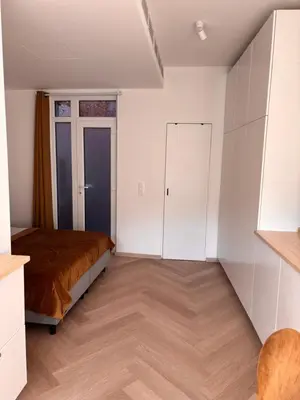 a bedroom with a bed and a closet at Studio Miravelle in Antwerp