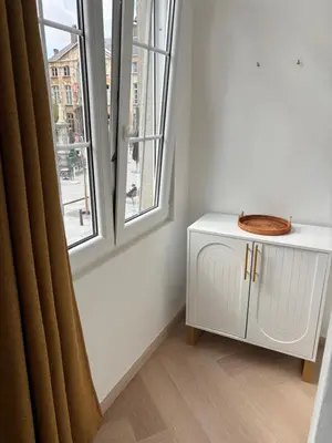 a white cabinet in a room with a window at Studio Miravelle in Antwerp