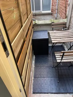 an open door to a patio with two benches at Studio Miravelle in Antwerp