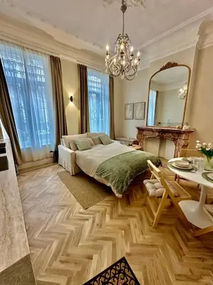 a bedroom with a bed and a mirror and a table at charm and comfort in Brussels