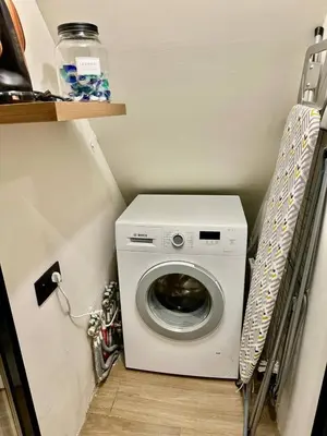 a washer and dryer in a small room at charm and comfort in Brussels