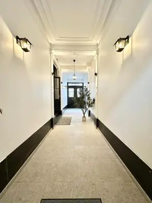 a hallway with white walls and a white ceiling at charm and comfort in Brussels