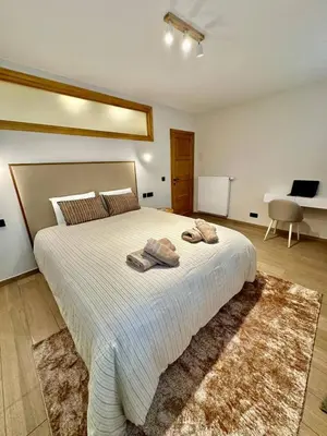 a bedroom with a large bed with two towels on it at charm and comfort in Brussels