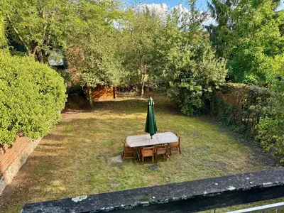 an umbrella and a table and chairs in a yard at 3BR Villa with Big Garden, Ping-Pong, Cinema, Bath in Ghent