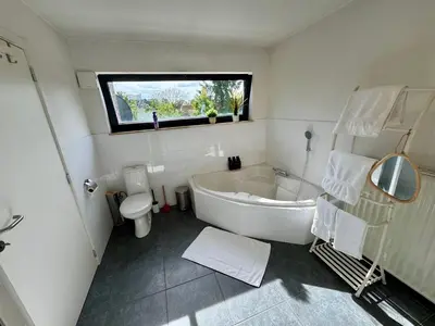 a bathroom with a tub and a toilet and a sink at 3BR Villa with Big Garden, Ping-Pong, Cinema, Bath in Ghent