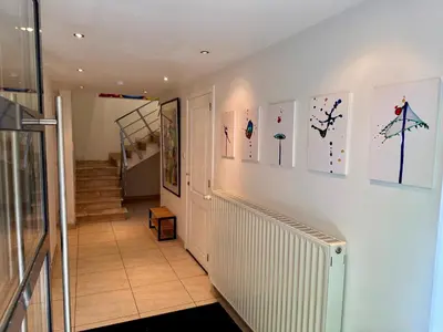 a hallway with some pictures on a wall at 3BR Villa with Big Garden, Ping-Pong, Cinema, Bath in Ghent