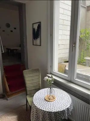 a table with a vase of flowers on it at Big beautiful appartement in center of Antwerpen in Antwerp