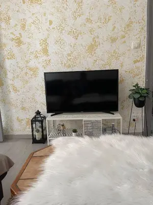 a living room with a flat screen tv on a table at Big beautiful appartement in center of Antwerpen in Antwerp