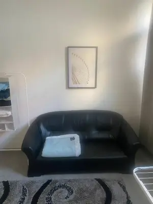 a black leather couch in a living room at Big beautiful appartement in center of Antwerpen in Antwerp