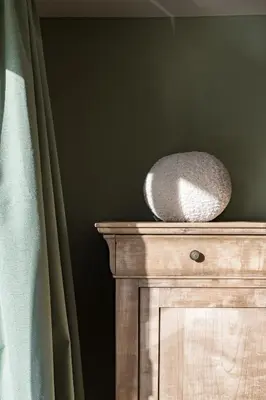 a wooden cabinet with a stone bowl on top of it at Adorable maison 3ch proche de Bruxelles-Tervuren in Tervuren