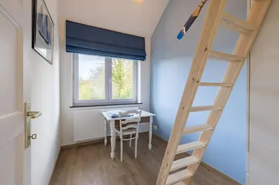 a room with a ladder and a table and a window at Adorable maison 3ch proche de Bruxelles-Tervuren in Tervuren