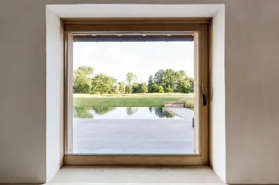 an open door with a view of a golf course at De Middenblijk in Turnhout