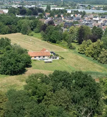 an aerial view of a house in a field at De Middenblijk in Turnhout