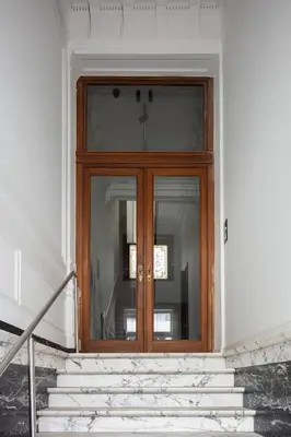 a wooden door on a building with stairs at Rietveldhouse Gent in Ghent
