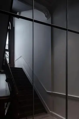 a staircase in a building with a glass wall at Rietveldhouse Gent in Ghent