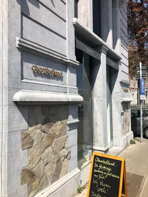 a building with a sign in front of it at Rietveldhouse Gent in Ghent