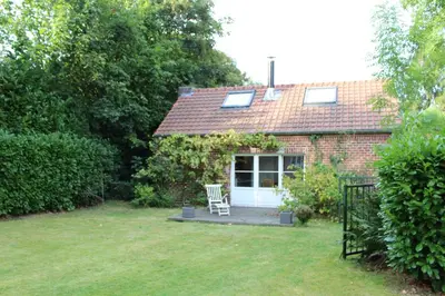 a brick house with a porch and a white door at Casa Terlinden in Brussels